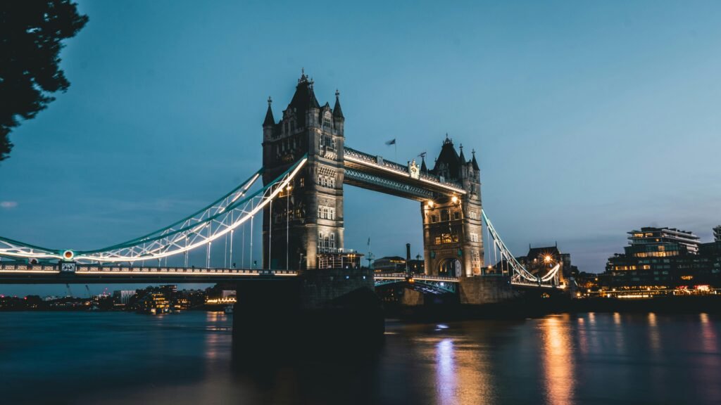 Stunning view of Tower Bridge glowing at night over the River Thames in London.